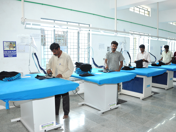 Steam pressing garments on industrial ironing tables