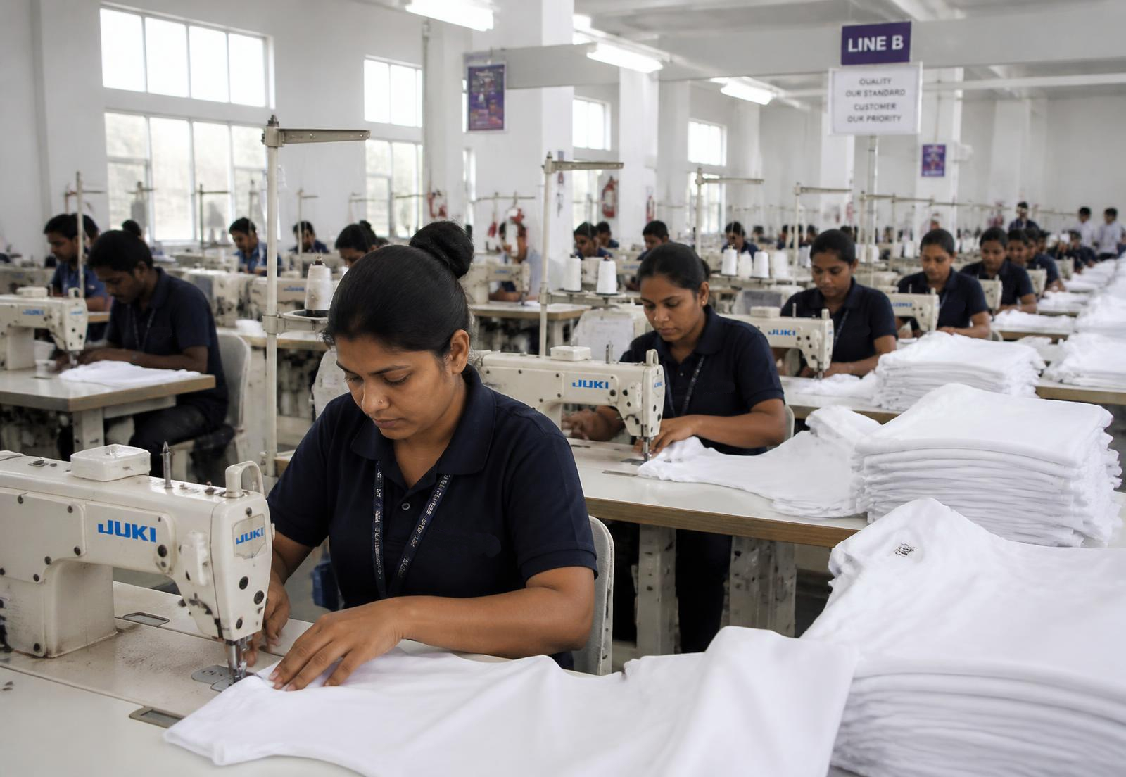Stitching unit with rows of industrial sewing machines at Texland Impex