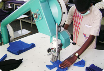 Layered fabric being cut on a cutting table